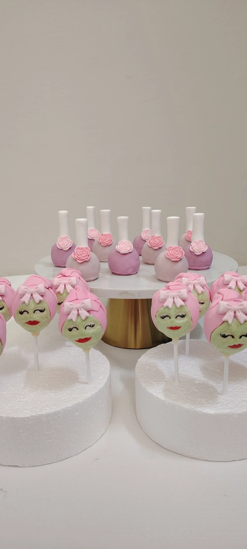 Pink decorated cake pops with rose and character details