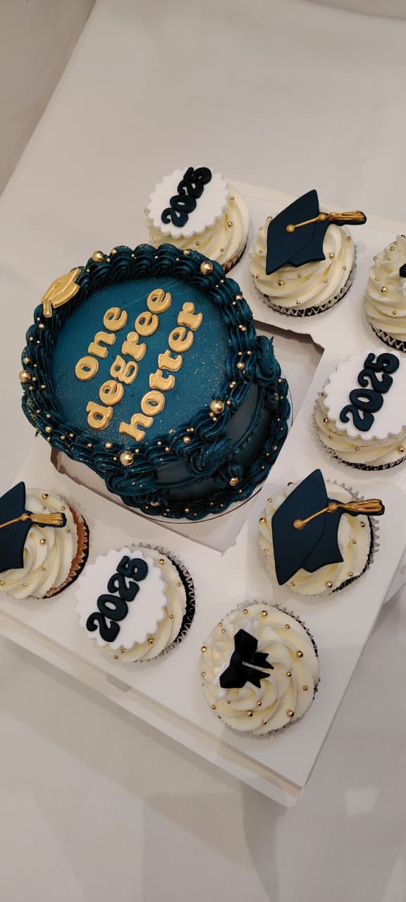 Graduation celebration cake with matching navy and gold cupcakes